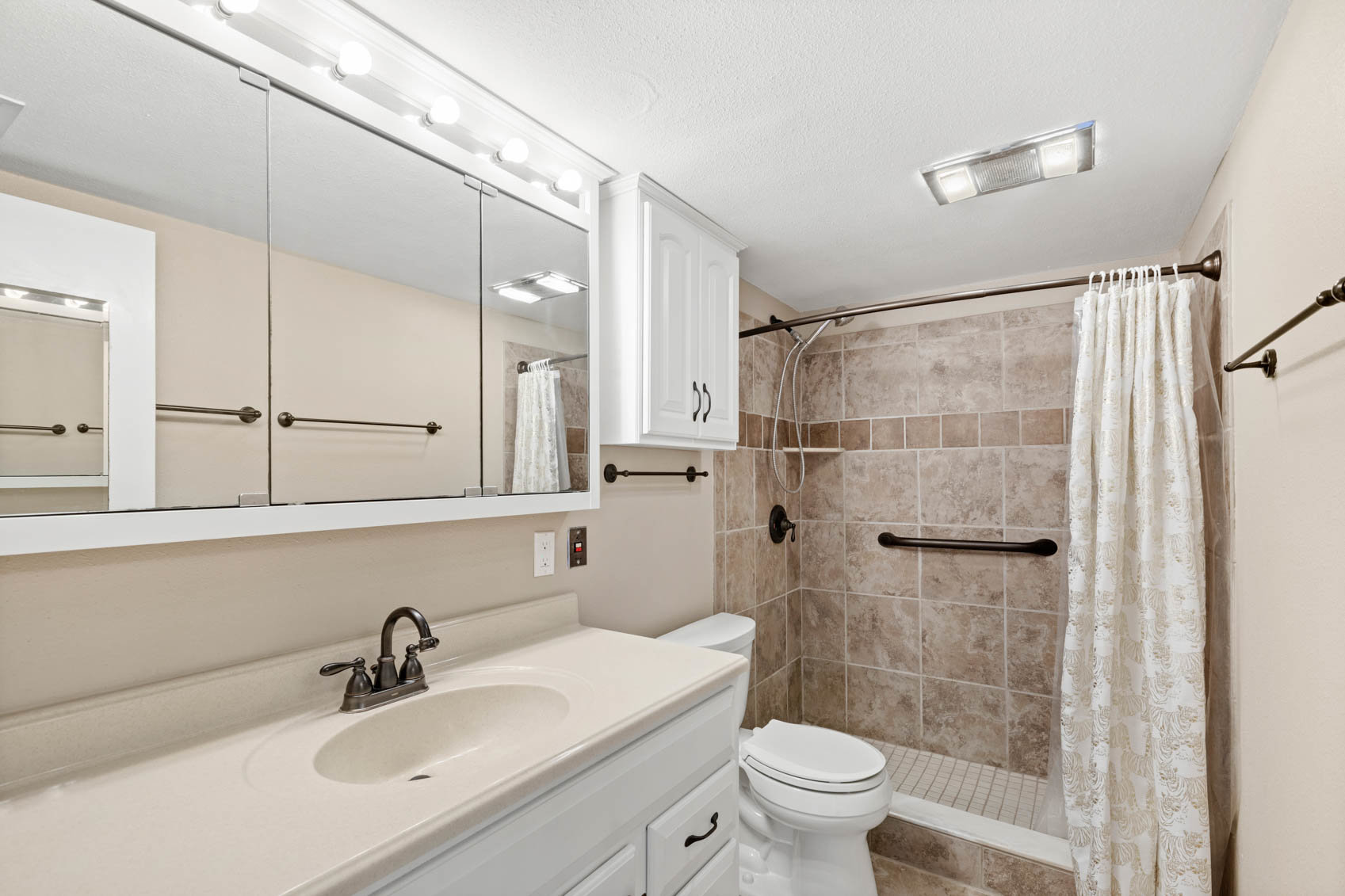 bathroom with off white counter and sink